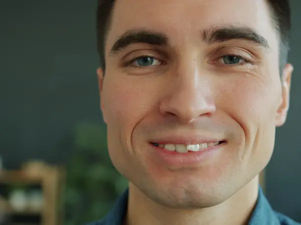 A young man smiling with straight, even teeth