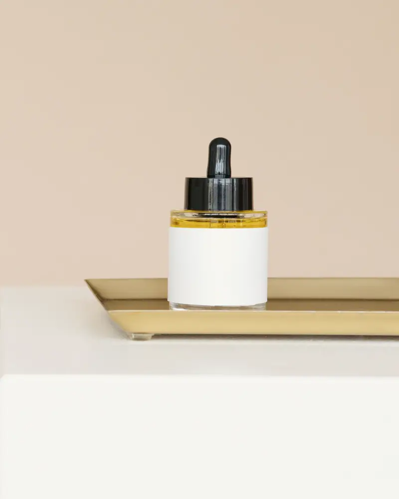 Prickly Pear Barrier Serum in a glass dropper bottle on a brass tray