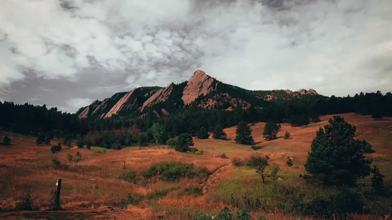 The Flatirons rock formations above Boulder under a stormy sky