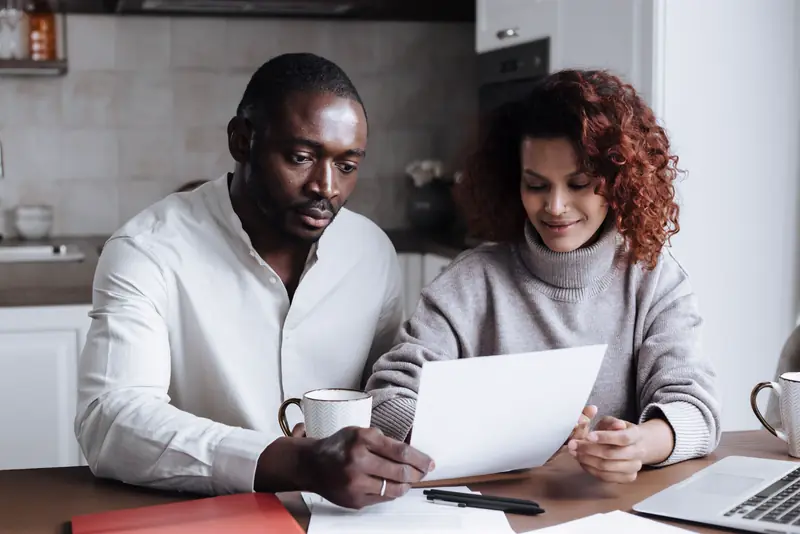 Couple reviewing an estimate together at their kitchen table