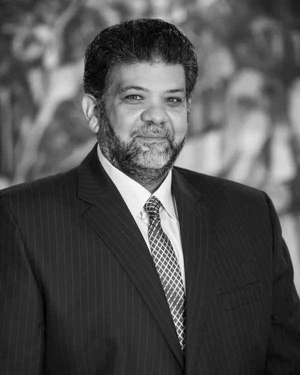 Theodore Ashby in a pinstripe suit and patterned tie