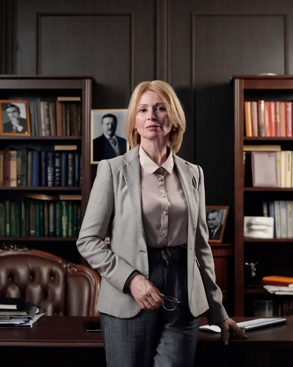 Claire Whitlock standing in the firm library