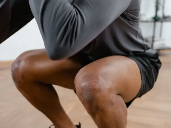 An athlete lowers into a deep squat.