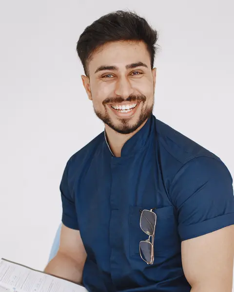 Portrait of Omar Haddad in navy scrubs.