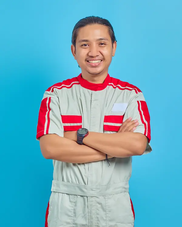 Portrait of Luis Ortega smiling with his arms crossed