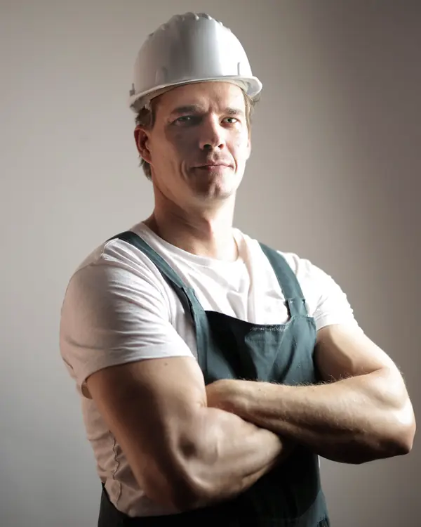 Portrait of Owen Park in a hard hat and work apron