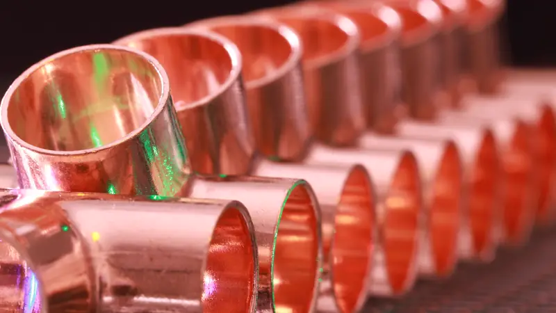 A row of new copper pipe fittings