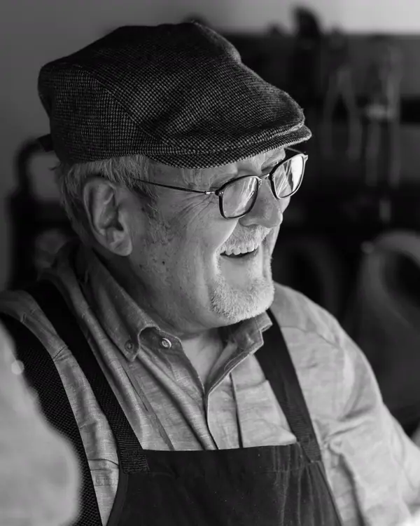 Walt Hartley, the founder, smiling in his work apron