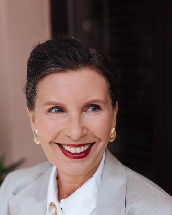 Juliette Marsh in a white blazer, smiling