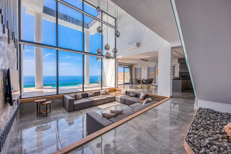 Double-height living room with a wall of glass facing the Gulf