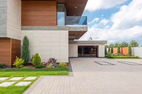 Side view of the home with a cedar-clad balcony over the garage