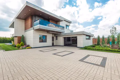 Wide paved driveway in front of the two-car garage