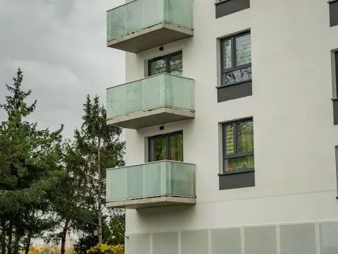 Modern condo building with frosted glass balconies