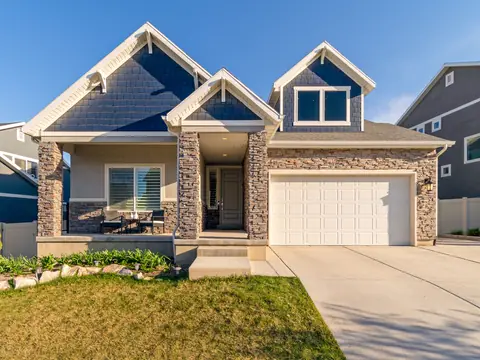 Two-story new home with a stone front, gabled roof and a two-car garage