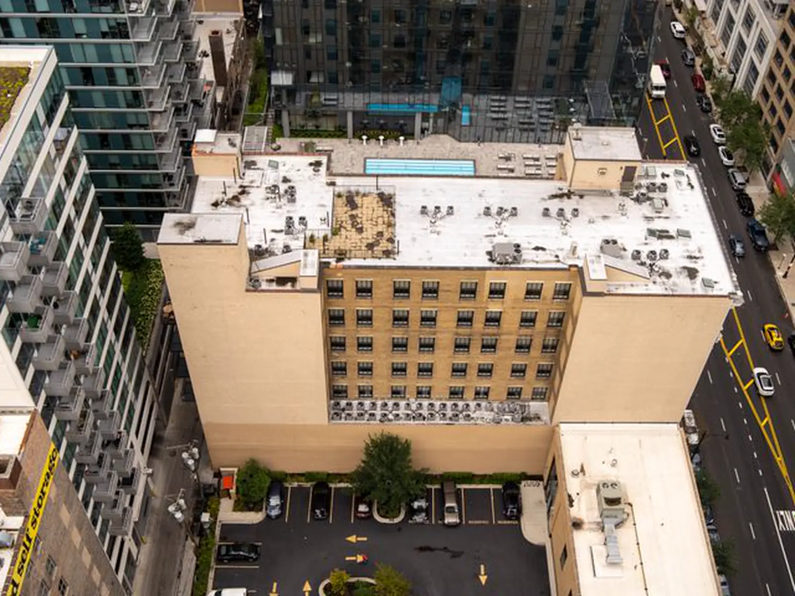 Aerial view of a downtown Chicago building with a white low-slope roof and rooftop equipment