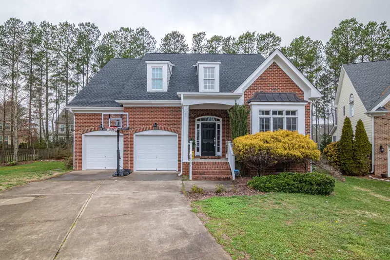 Brick two-story home in Keller with a new charcoal shingle roof
