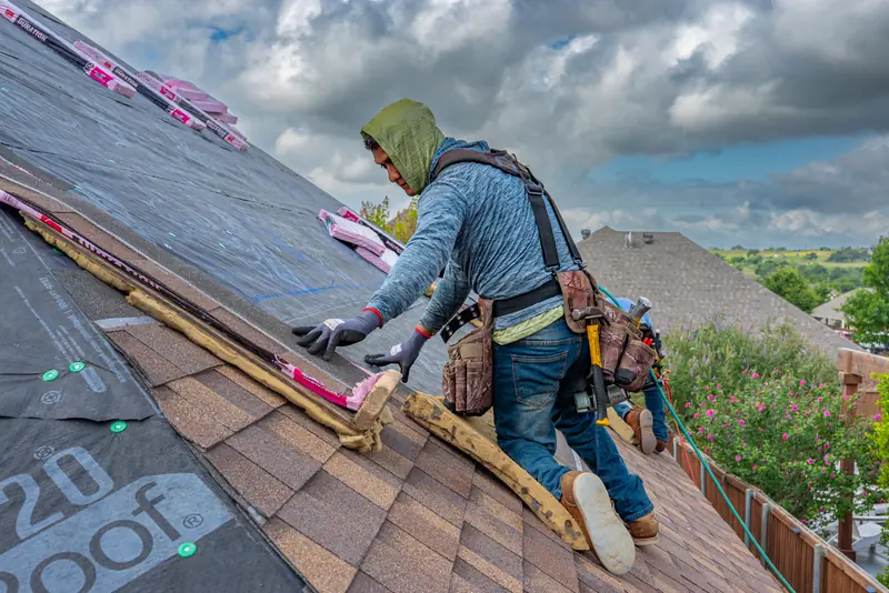 Roofer laying new shingles on a Fort Worth home