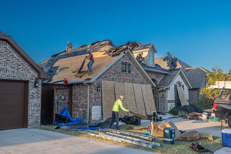 Crew working on the roof of a brick home in Fort Worth