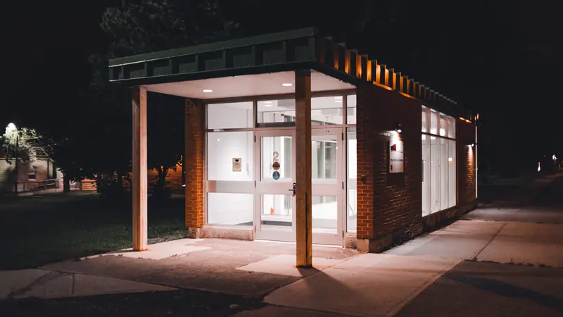 The lit entrance of a small clinic building at night
