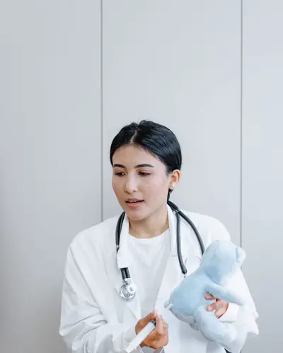 Grace Lin holding a stuffed toy and a stethoscope