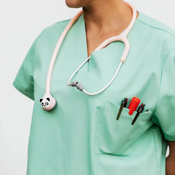 A provider in mint scrubs wears a stethoscope with a small panda on it