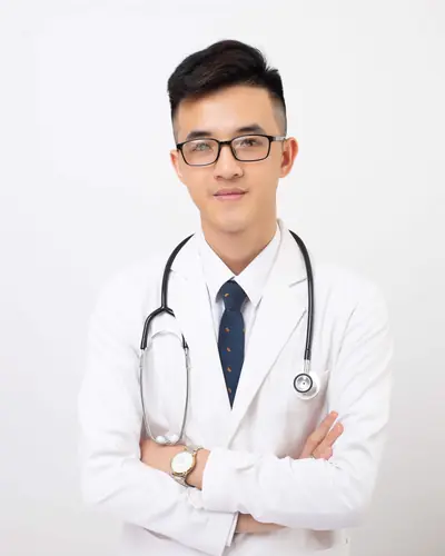 Dr. Owen Park in a white coat and glasses